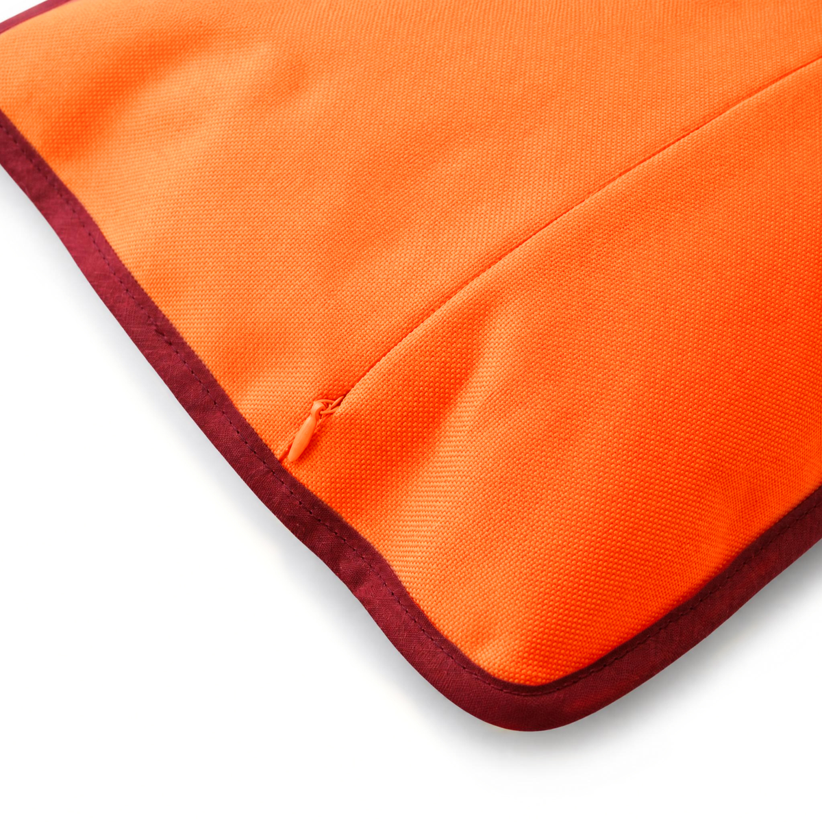 Détail du dos imperméable du coussin de plage Ruby ’72 avec fermeture éclair invisible et finition en biais bordeaux